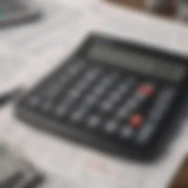 A calculator surrounded by various insurance documents